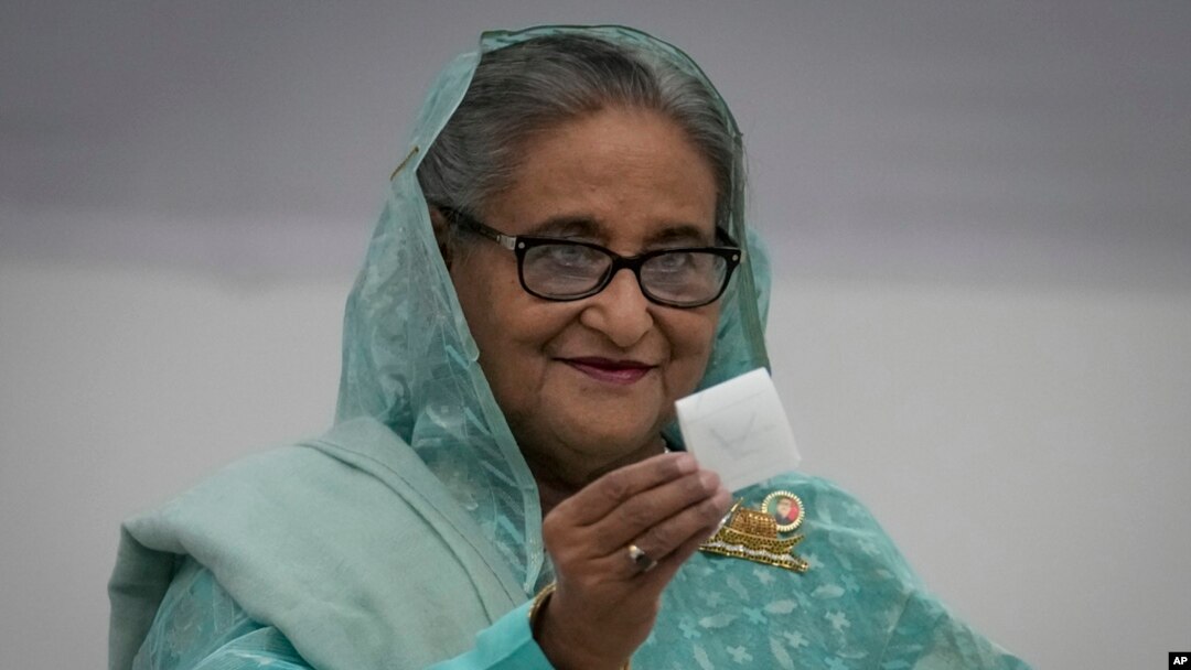 FILE - Bangladesh Prime Minister Sheikh Hasina shows her ballot paper as she casts her vote in Dhaka, Bangladesh, Jan. 7, 2024.