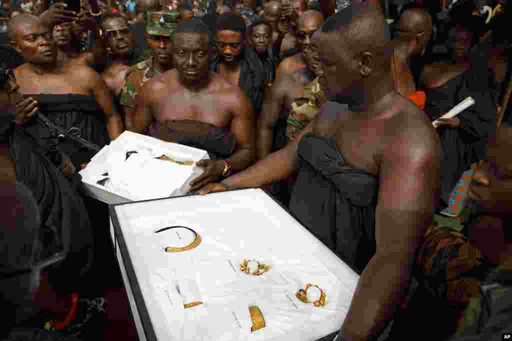 Artifacts returned from UCLA's Fowler Museum are carried to Asante King Otumfuo Osei Tutu II at the Manhyia Palace in Kumasi, Ghana, Feb. 8, 2024. Seven royal artifacts which were looted by British forces from Ghana's ancient Asante kingdom in the 19th century were returned by the museum.