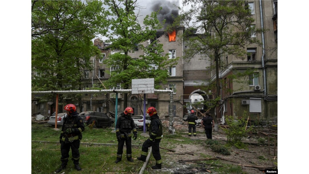 Firefighters work at a site of an apartment building hit by a Russian missile strike, amid Russia's attack on Ukraine, in Dnipro, Ukraine, April 19, 2024.