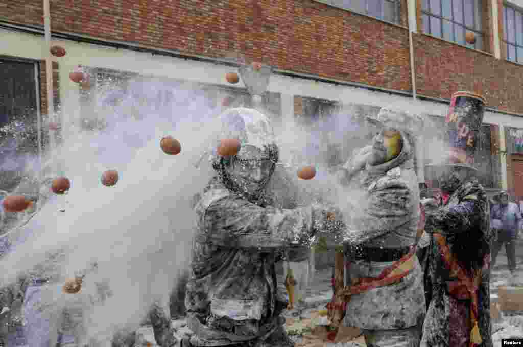 Revellers battle with flour and eggs during the traditional "Els Enfarinats" (The Floured) festival in Ibi, Spain.