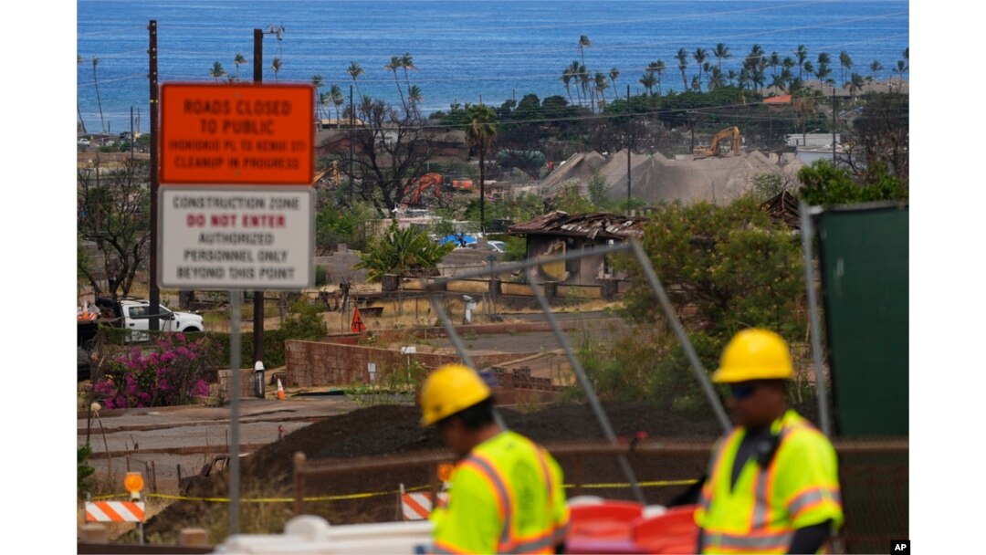 FILE - Crews work to clean debris and repave roads, July 6, 2024, in Lahaina, Hawaii.
