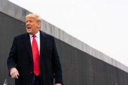 FILE - President Donald Trump reacts after speaking near a section of the U.S.-Mexico border wall, Jan. 12, 2021, in Alamo, Texas.