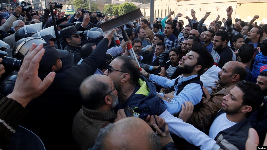 FILE - Christians clash with riot police in front of Cairo’s Coptic Cathedral after an explosion inside the cathedral in Cairo, Egypt, Dec. 11, 2016. 