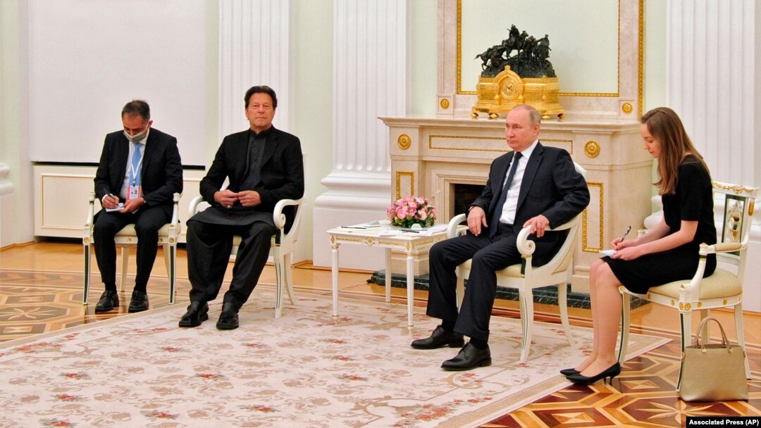 Russian President Vladimir Putin, center right, and Pakistan's Prime Minister Imran Khan, center left, talk during their meeting in Moscow, Feb. 24, 2022.