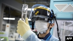 资料照片：一名工作人员正在检测福岛核废水中氚放射性元素的含量（2022年3月5日）