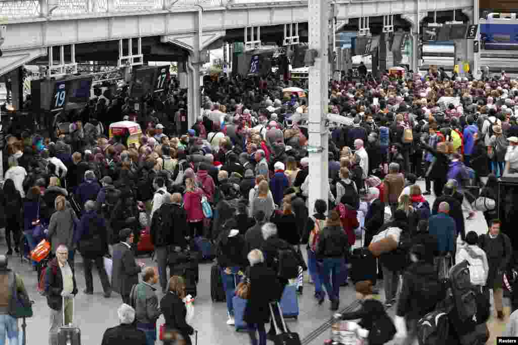 Passengers try to get in a train at Gare de Lyon railway station in Paris, France, during a national railway strike by French railway unions workers from the France's rail-operator SNCF.