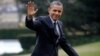  President Barack Obama waves following his arrival on Marine One helicopter from the House Democratic Issues Conference in Lansdowne, Virginia, as he walks across the South Lawn of the White House in Washington, February 7, 2013.