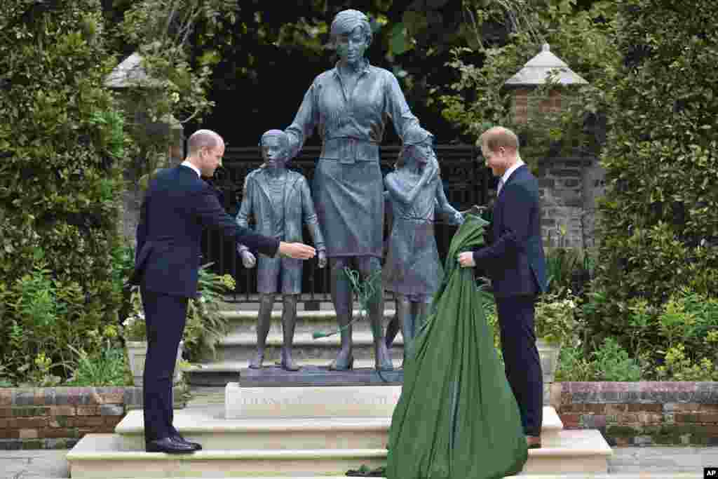 Britain's Prince William and Prince Harry unveil a statue of their mother Princess Diana, on what would have been her 60th birthday, in the Sunken Garden at Kensington Palace, London.