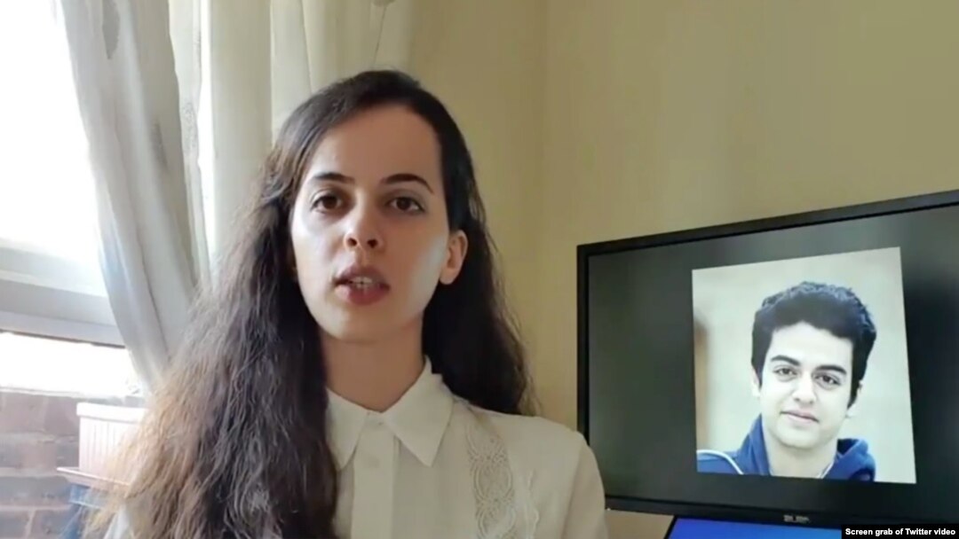 Screen grab of May 5, 2020, Twitter video in which Aida Younesi, Britain-based sister of student Ali Younesi whom Iranian authorities detained on April 10, 2020, criticizes Iran's treatment of her brother, seen on screen behind her.