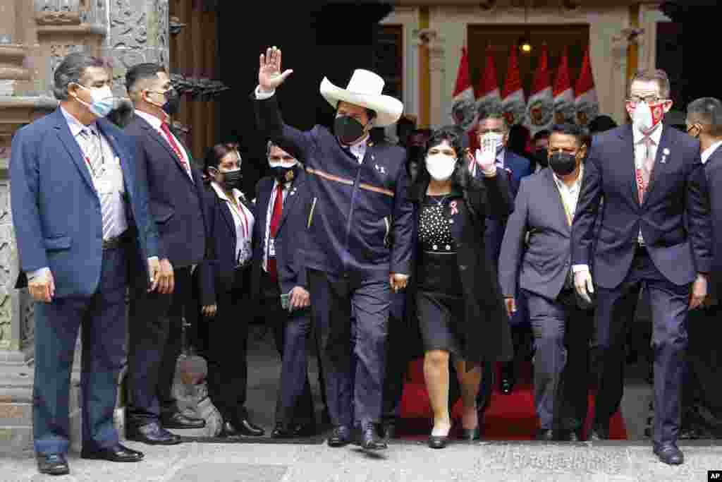 Peru's President-elect Pedro Castillo and his wife Lilia Paredes wave as they leave the Foreign Ministry to go to Congress for his swearing-in ceremony on his Inauguration Day in Lima, July 28, 2021.