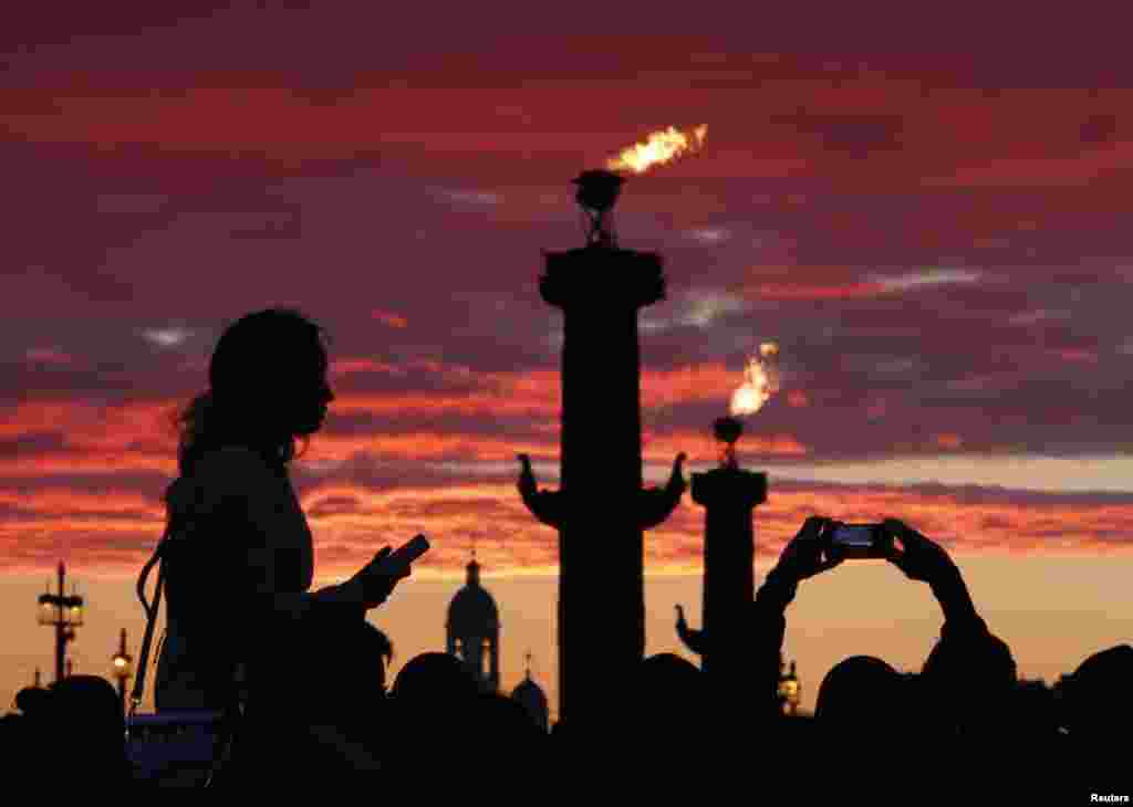 People wait to watch fireworks during the Scarlet Sails festivities marking school graduation, in St. Petersburg, Russia.