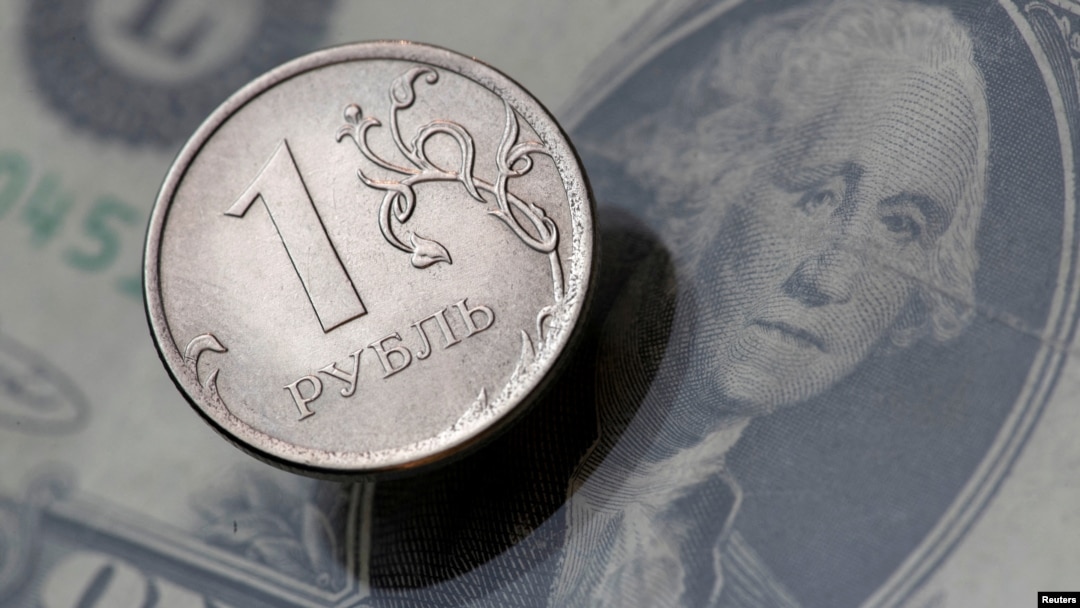 FILE - A view shows a Russian rouble coin and a U.S. dollar banknote in this picture illustration taken October 26, 2018.