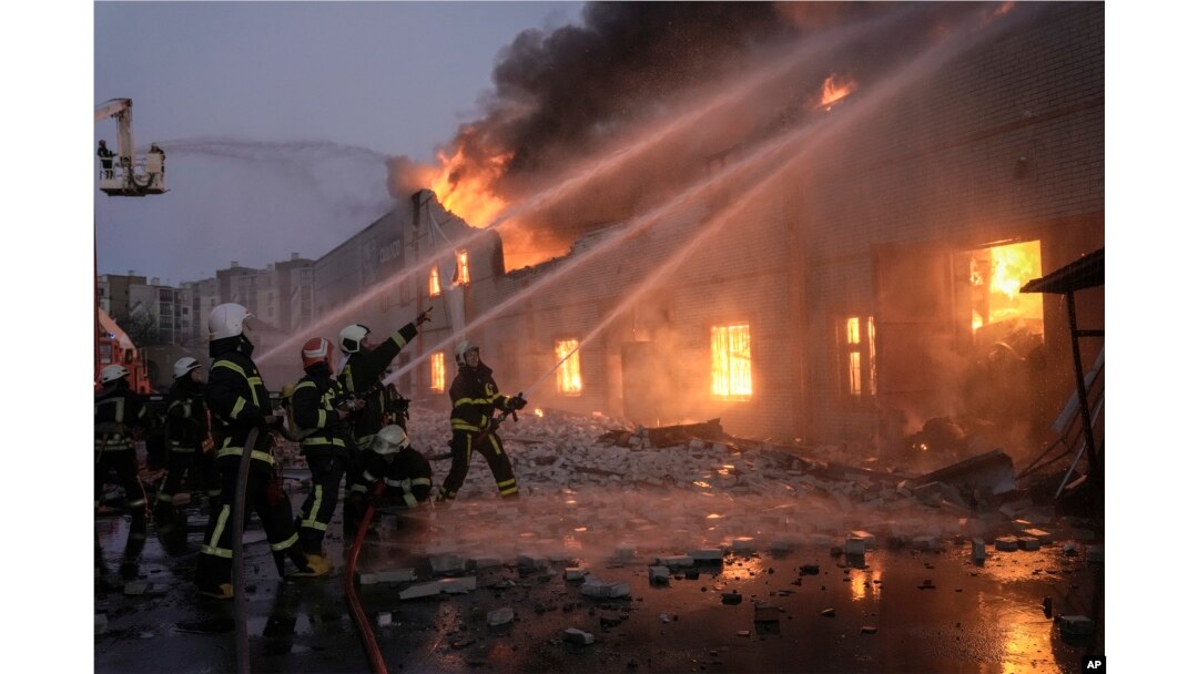 Ukrainian firefighters extinguish a blaze at a warehouse after a bombing in Kyiv, March 17, 2022.