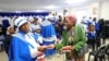 Faithful hand out pamphlets on coronavirus disease (COVID-19) at the end of service, at the Apostolic Christian Church in Kagiso, west of Johannesburg, South Africa, March 22, 2020.