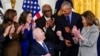 President Joe Biden looks to former President Barack Obama after signing an executive order during an event about the Affordable Care Act, in the East Room of the White House in Washington, April 5, 2022. 
