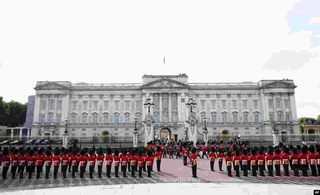 The coffin of Queen Elizabeth II, draped in the Royal Standard with the Imperial State Crown placed on top, is carried on a horse-drawn gun carriage of the King's Troop Royal Horse Artillery, outside Buckingham Palace, London, Sept. 14, 2022.