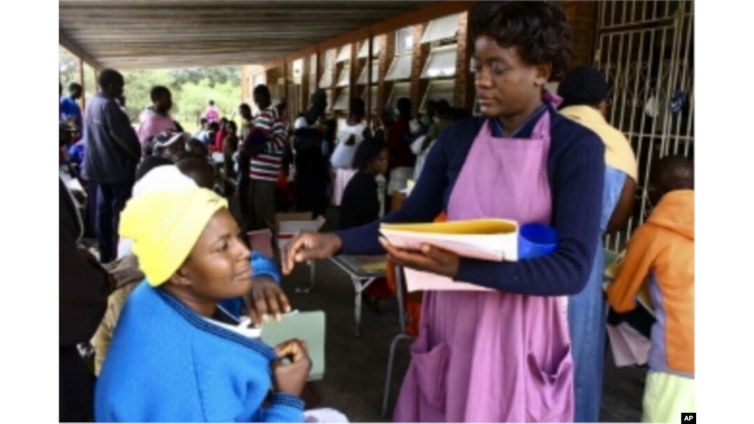 A MSF worker takes details from patients at a clinic in southern Zimbabwe