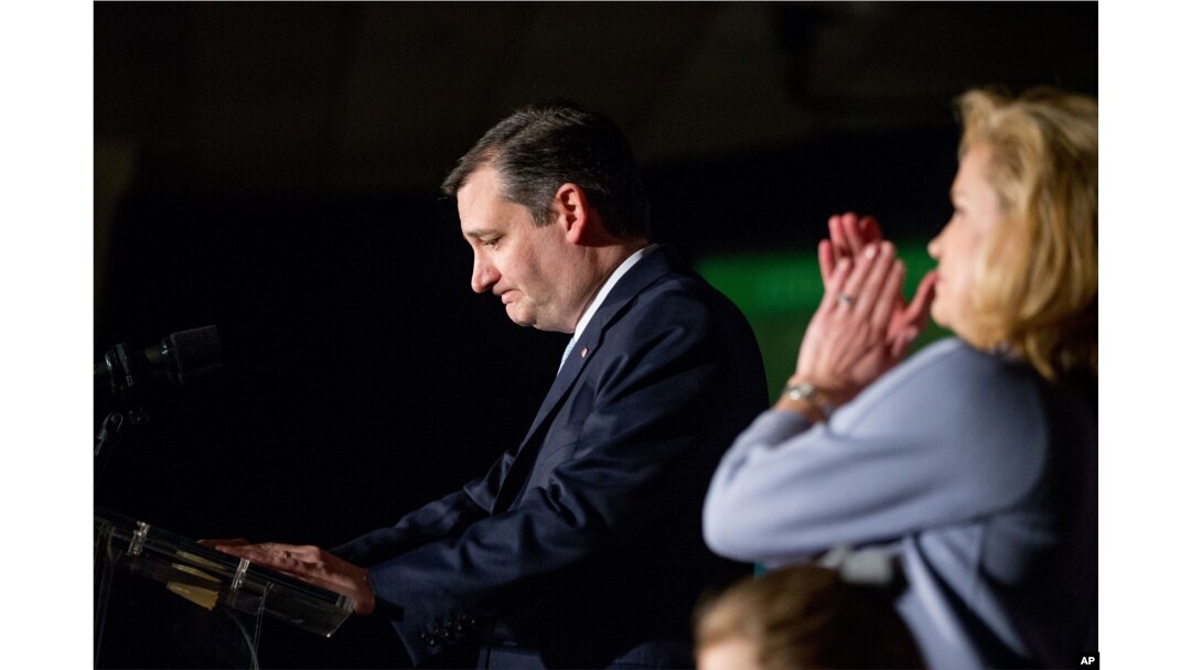 Republican presidential candidate Sen. Ted Cruz, accompanied by his wife, Heidi, right, pauses while speaking at his South Carolina primary night rally at the South Carolina State Fairgrounds in Columbia, Feb. 20, 2016.