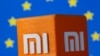 A 3D printed Xiaomi logo is seen in front of displayed EU flag in this illustration taken, Sept; 30, 2021. 