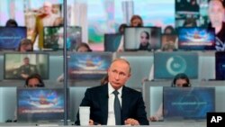 Russian President Vladimir Putin listens to a question during his annual call-in show in Moscow, June 7, 2018. 