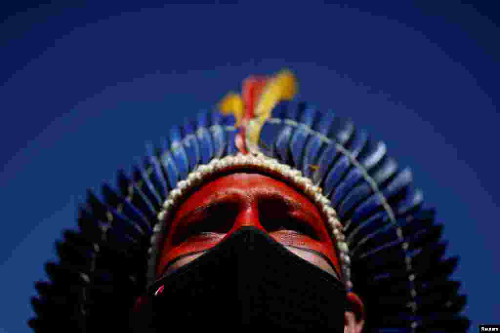 Davi Tupiniquin of the Tupiniquin tribe looks on during a protest for land demarcation and against President Jair Bolsonaro's government, next to the National Congress in Brasilia, Brazil.