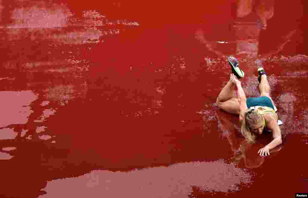 Genevieve Gregson of Australia reacts after falling during the women's 3,000-meter steeplechase final at the Olympic Stadium in Tokyo, Japan.