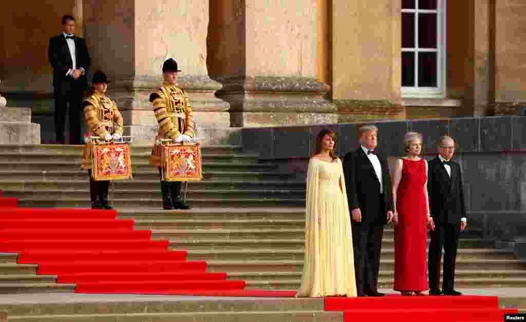 British Prime Minster Theresa May and her husband Philip stand together with U.S. President Donald Trump and First Lady Melania Trump at the entrance to Blenheim Palace, where they are attending a dinner with specially invited guests and business leaders, and business leaders, near Oxford, Britain.