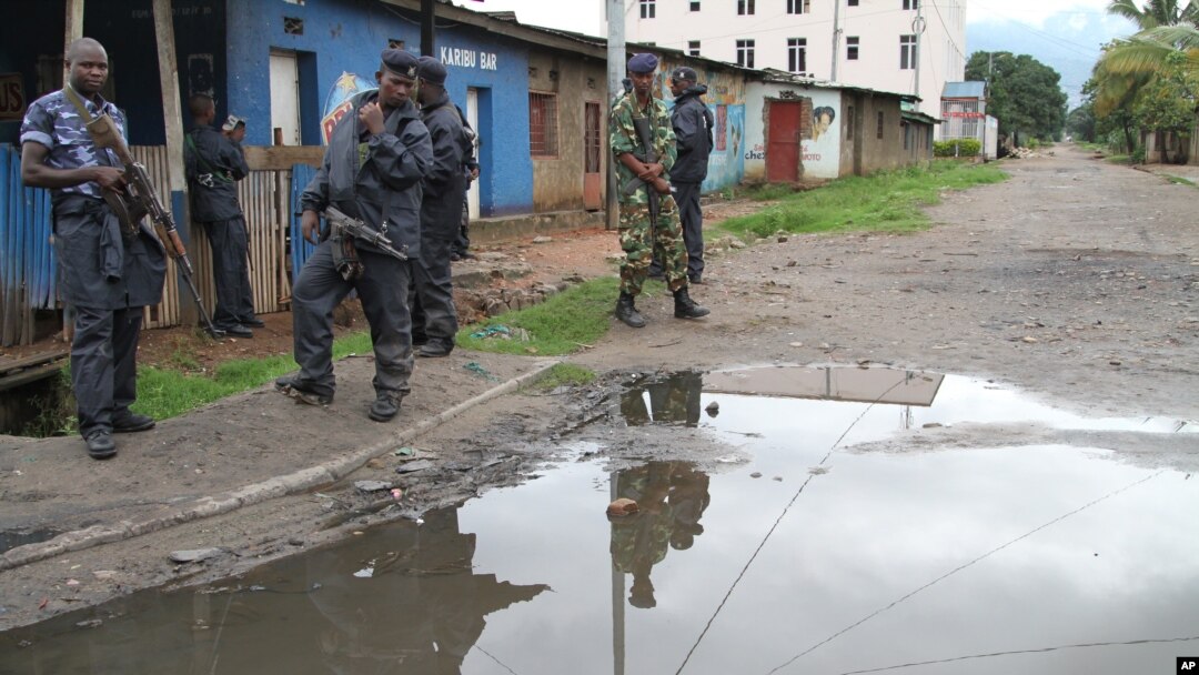 Burundian police and soldiers guard a deserted street in Bujumbura, Burundi, Nov. 8, 2015. 
