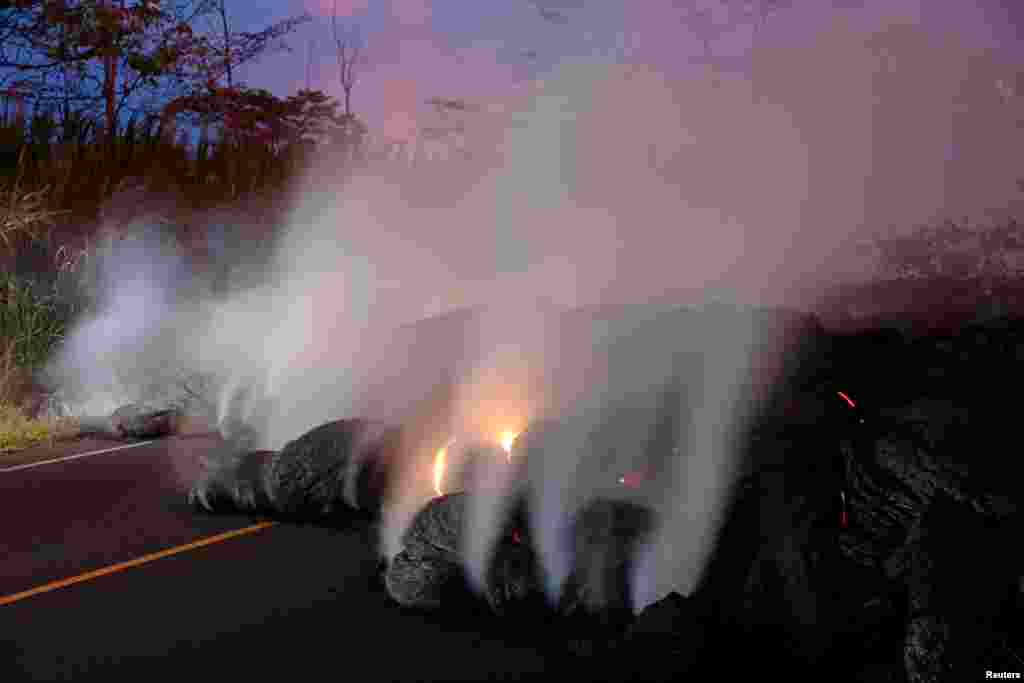 Volcanic gases rise from the Kilauea lava flow that crossed Pohoiki Road near Highway 132, near Pahoa, Hawaii, May 28, 2018.