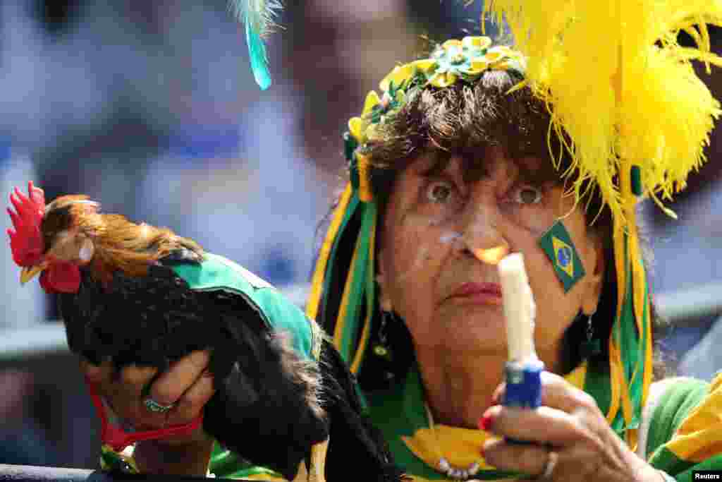 A fan reacts during the live broadcast of a 2018 Russia World Cup soccer match between Brazil and Mexico in Rio de Janeiro, Brazil.