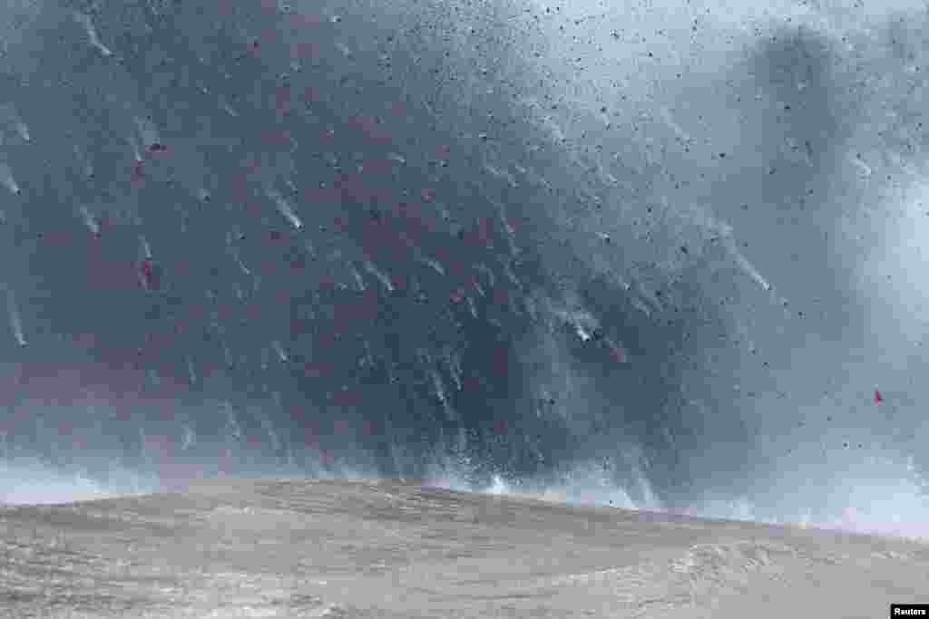 Lava flows into the Pacific Ocean, southeast of Pahoa, during ongoing eruptions of the Kilauea Volcano in Hawaii, May 20, 2018.