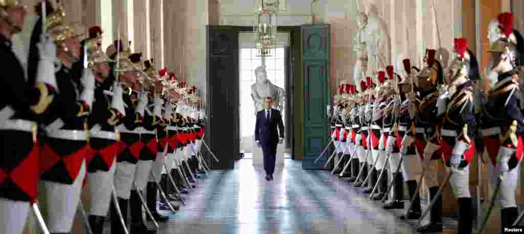 French President Emmanuel Macron walks through the Galerie des Bustes (Busts Gallery) to access the Versailles Palace's hemicycle to address both the upper and lower houses of the French parliament (National Assembly and Senate) at a special session in Versailles near Paris.