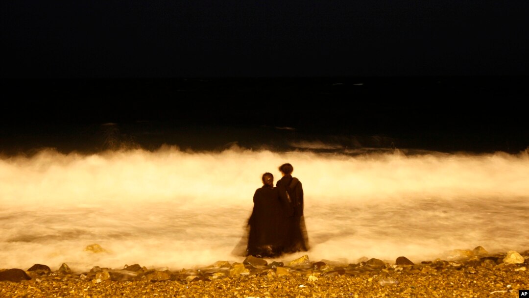 FILE - two veiled Saudi women enjoy the Red Sea at night, in Jiddah, Saudi Arabia, Dec. 26, 2007. Saudi Arabia is planning to build a semi-autonomous luxury travel destination along its Red Sea coast that visitors can reach without a visa. The Red Sea area, which will include diving attractions and a nature reserve, will be developed with seed capital from the country's Public Investment Fund. 