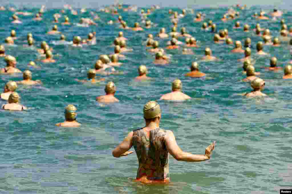 People participate in the annual public Lake Zurich crossing swimming event in Zurich, Switzerland, July 11, 2018.