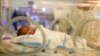 FILE - Melinda Star Guido lies in an incubator at the Los Angeles County-USC Medical Center in Los Angeles, Dec. 14, 2011. At birth, Melinda Star Guido tipped the scales at 9 1/2 ounces. Most babies her size don’t survive, but doctors are preparing to send her home.