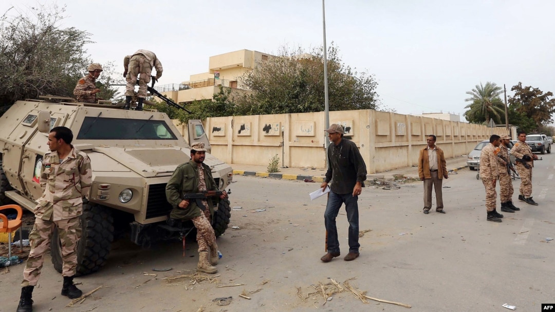 Libyan soldiers, some on an armored personnel carrier (APC), deploy in a Tripoli's neighborhood after militias were ordered to leave the capital following deadly weekend clashes, Nov. 18, 2013. 