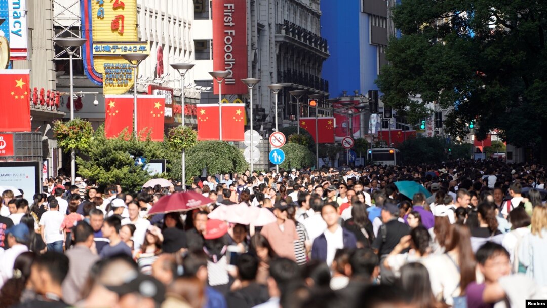 Chinese national flags are seen as tourists throng the Nanjing pedestrian road, a main shopping area, on China's 69th National Day in Shanghai, China, Oct. 1, 2018.