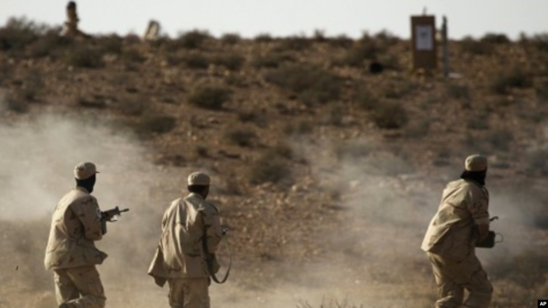 Libyan rebel fighters with the Tripoli Revolutionary Brigade take part in a live firing exercise near Nalut in western Libya, August 6, 2011.