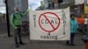 Protesters hold a banner against mining coking coal in the West Cumbria area of northern England, as they stand near the Scottish Event Campus, the venue for the COP26 U.N. Climate Summit in Glasgow on Nov. 2, 2021.