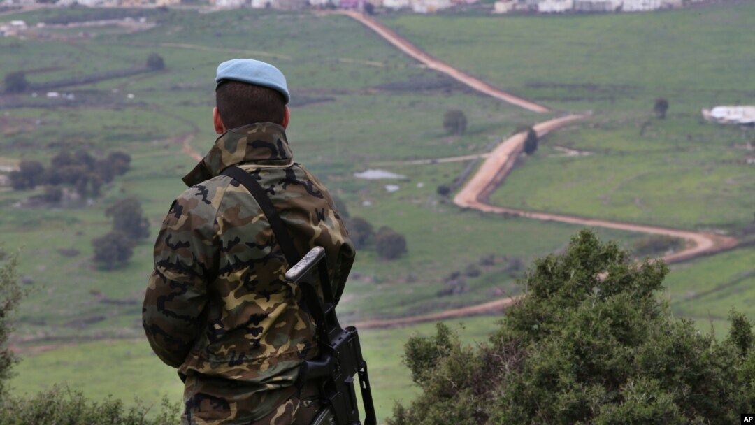 FILE - A Spanish U.N. peacekeeper looks to the U.N-demarcated Blue Line border between Lebanon and Israel, Feb. 24, 2015.