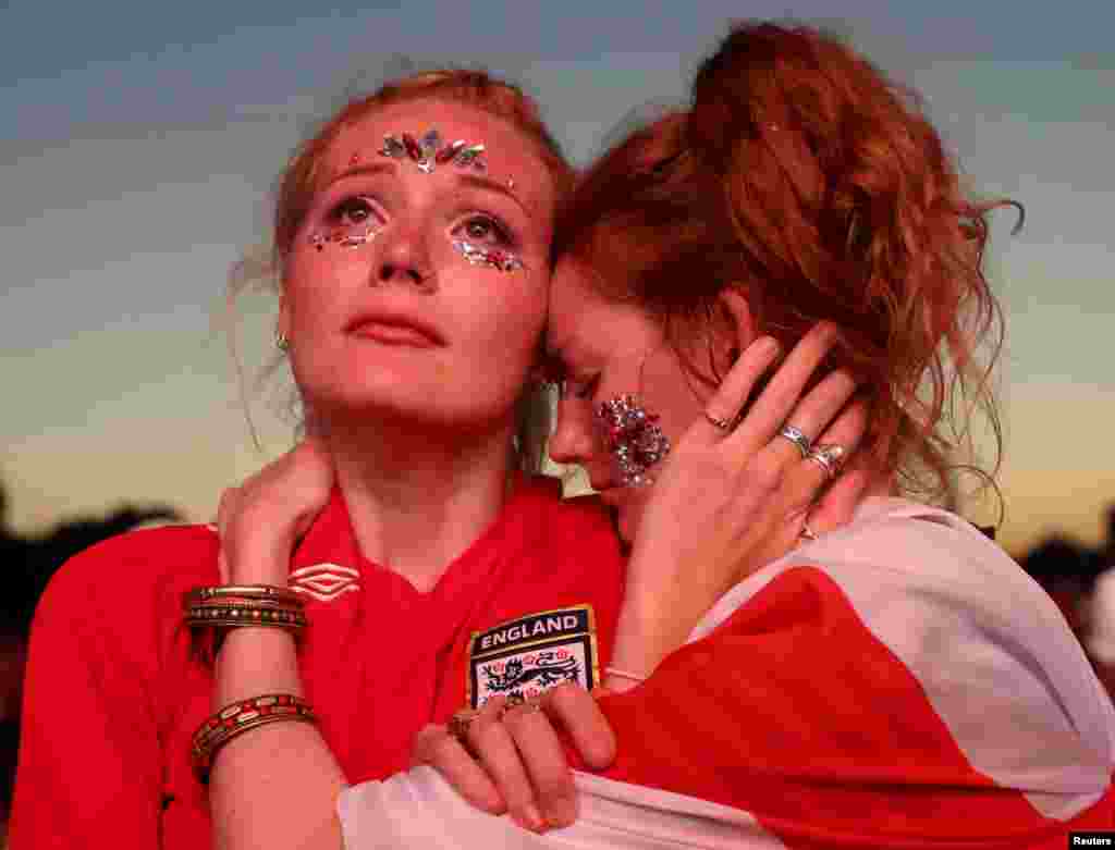 Fans of England's soccer team in Hyde Park in London react after England loses the 2018 World Cup semi-final against Croatia in Moscow, Russia, July 11, 2018.