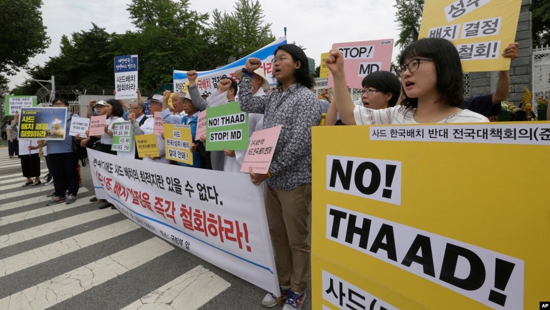 FILE - Protesters shout slogans during a rally to denounce deploying the Terminal High-Altitude Area Defense, or THAAD, in front of the Defense Ministry in Seoul, South Korea, Wednesday, July 13, 2016. President Park said North Korea's growing ballistic missile capabilities left the government no choice but to deploy the system.
