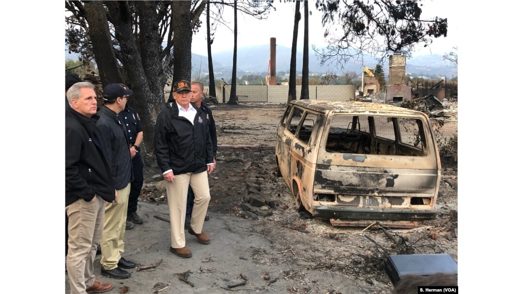 President Donald Trump surveys the damage done by the Woolsey Fire in Malibu, Calif., Nov. 17, 2018. At left is Congressman Kevin McCarthy, who represents a nearby district.
