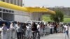 Shoppers queue to stock up on groceries at a Makro Store at Strubens Valley, ahead of a nationwide lockdown for 21 days to try to contain the coronavirus disease outbreak, in Johannesburg, South Africa, March 24, 2020. 
