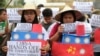 FILE - Filipino student activists hold mock Chinese ships to protest recent island-building and alleged militarization by China off the disputed Spratlys group of islands in the South China Sea, during a rally in Manila, Philippines, March 3, 2016.