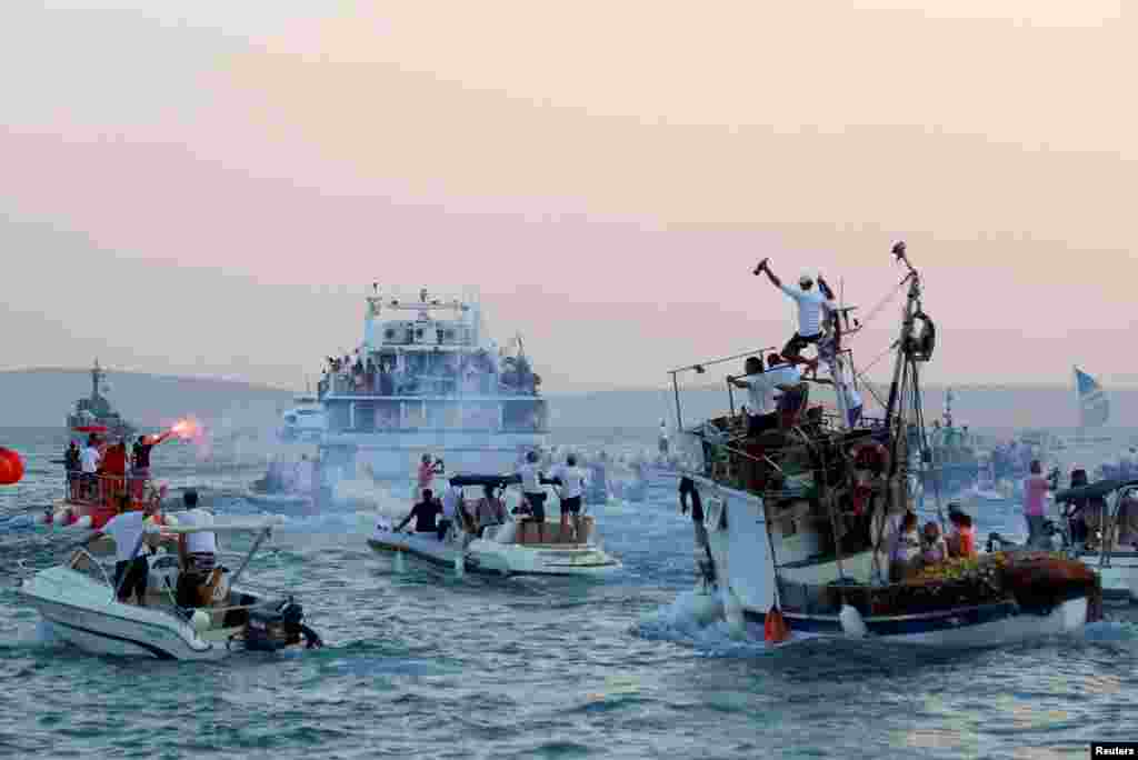 People on boats follow catamaran that carries a coffin of the singer Oliver Dragojevic during his funeral in Split, Croatia, July 31, 2018.
