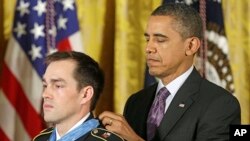President Barack Obama bestows the Medal of Honor on retired Staff Sgt. Clinton Romesha for conspicuous gallantry, Feb. 11, 2013, in the East Room of the White House.