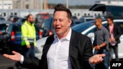 (FILES) In this file photo taken on September 03, 2020, Tesla CEO Elon Musk arrives to visit the construction site of the future US electric car giant Tesla in Gruenheide near Berlin. - Musk says he has tested positive for the novel coronavirus…