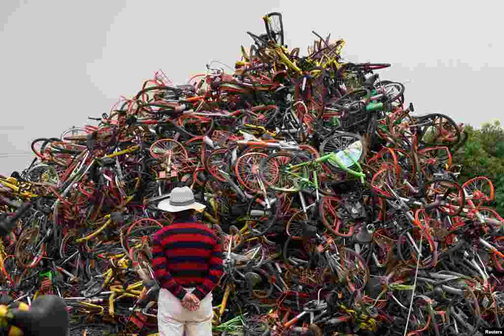 Bicycles of various bike-sharing services are seen in a garbage dump in Shanghai, China.