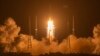 FILE - In this Nov. 24, 2020, photo, a Long March-5 rocket carrying the Chang'e 5 lunar mission lifts off at the Wenchang Space Launch Center in Wenchang in southern China's Hainan Province.